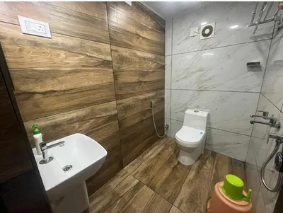 a bathroom with a sink and a toilet at Vyshnavi home stay in Thanniyam