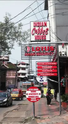 a sign for a restaurant on a city street at Lotus Grand Residency in Angādipuram