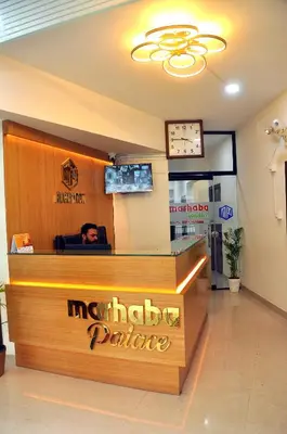a counter in a restaurant with a man behind the counter at MARHABA PALACE in Kozhikode