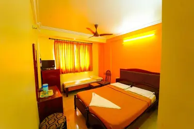 a hotel room with a bed and a window at AMOGHA RESIDENCY in Mysore