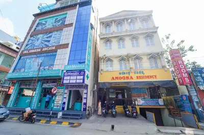 a group of buildings on a city street at AMOGHA RESIDENCY in Mysore