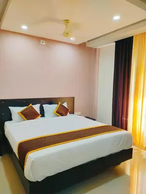 a bedroom with a large bed in a room at NEW MOUNT RESIDENCY in Sultan Bathery