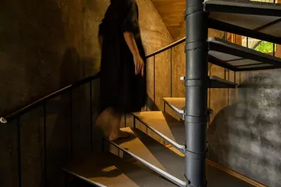 a person walking up the stairs of a room at Bimal's Casa de Papel in Kadikkād