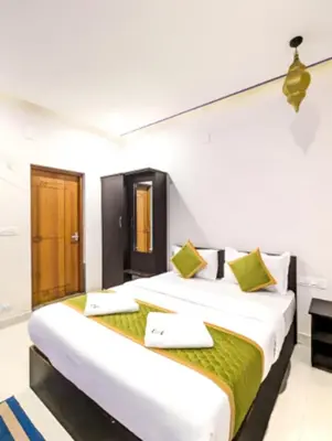 a bedroom with two beds in a room at Wayanad Valentine Pool Resort in Sultan Bathery