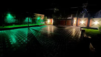 an empty street at night with green lights at Easy Inn Wayanad in Kaniyāmbetta
