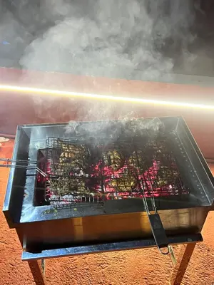 a grill with a bunch of food on it at Easy Inn Wayanad in Kaniyāmbetta