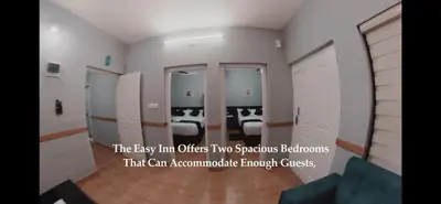 an empty room with two beds and a room with at Easy Inn Wayanad in Kaniyāmbetta