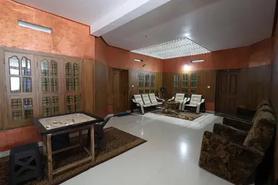 a large living room with a table and chairs at Wayanad regal residency in Kalpetta