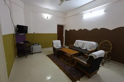 a living room with a couch and a table at Wayanad regal residency in Kalpetta