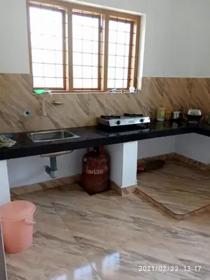 a kitchen with a counter top and a sink at Anna homestay in Chekadi