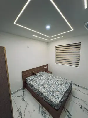 a bedroom with a bed in a room with marble floors at Chills homestay in Kalpetta