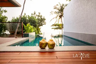 two vases sitting next to a swimming pool at LA RÊVE The Beach Villa in Malappuram