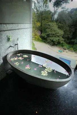 a bath tub filled with flowers on the ground at Elixir Woods Luxury Resort And Spa, Munnar in Munnar