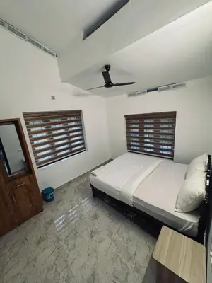 a bedroom with a bed and a ceiling at Chills homestay in Kalpetta