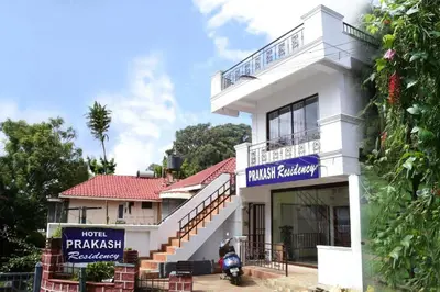 a white building with a sign in front of it at Ooty Prakash Residency in Ooty