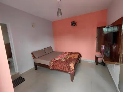 a bedroom with a bed in a room with red walls at Ooty Prakash Residency in Ooty