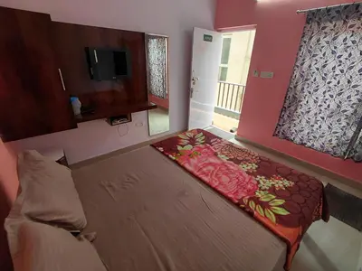 a small room with a bed and a window at Ooty Prakash Residency in Ooty