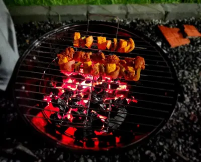 a bunch of food cooking on a grill at Cloud & Mist Inn-Whole Villa Stay with Mountain Views in Kotagiri, Near Ooty in Kotagiri