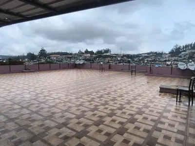 a large patio with a view of a city at J J HOMES in Ooty