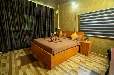 a bedroom with a large bed in a room at Hill Valley Farm House in Nelliyampathy