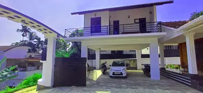 a car parked in front of a house at Empire Single Bedroom Villa with Common Pool in Meenangadi