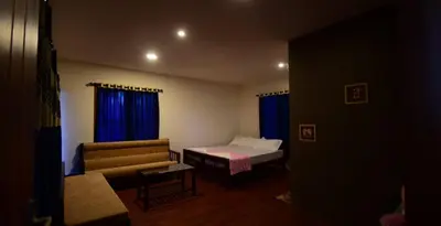 a living room with a bed and a couch at Greens Vista Homestay Wayanad Near Natural Stream and Pool in Panamaram