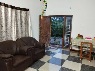 a living room with a couch and a table at SHI Triveni 1BHK at Coimbatore Outskirts in Irugūr