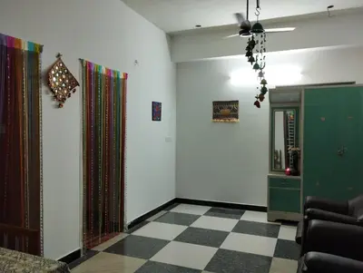 a living room with a checkered floor at SHI Triveni 1BHK at Coimbatore Outskirts in Irugūr