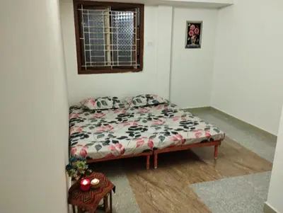 a small bedroom with a bed in a room at SHI Triveni 1BHK at Coimbatore Outskirts in Irugūr