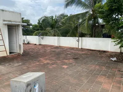 a brick patio in front of a white fence at Kamalam 3BHK Villa 1AC and 2 Non AC Bedrooms in Coimbatore