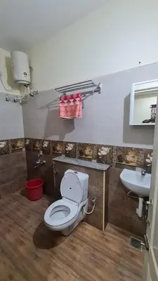 a bathroom with a toilet and a sink at Kamalam 3BHK Villa 1AC and 2 Non AC Bedrooms in Coimbatore
