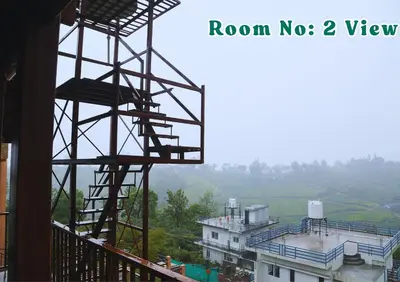 a view from a balcony of a building at Joy Eco Woodhouse - 3 Bhk House in Ooty