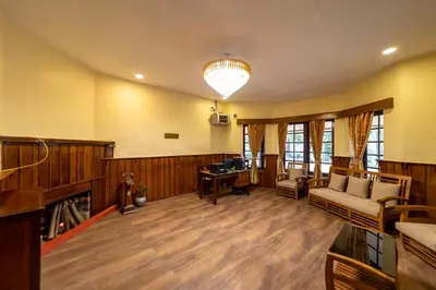 a living room with a couch and a desk at Harris Holiday Inn in Vālpārai