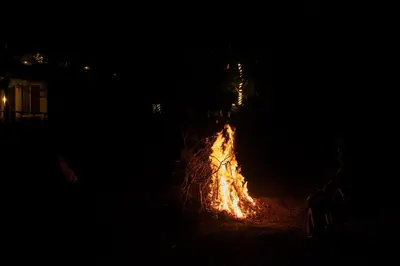 a fire is burning in a field at night at Harris Holiday Inn in Vālpārai