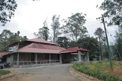 an old building with red roofs on a street at Harris Holiday Inn in Vālpārai