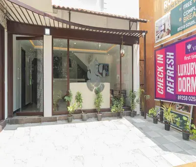 a store front with potted plants in front of it at Hotel Vinayaga Tiruppur in Tiruppūr
