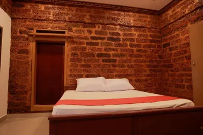 a bedroom with a brick wall with a bed at Best Heritage Home in Iritti