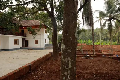 a house with a tree in front of a yard at Best Heritage Home in Iritti