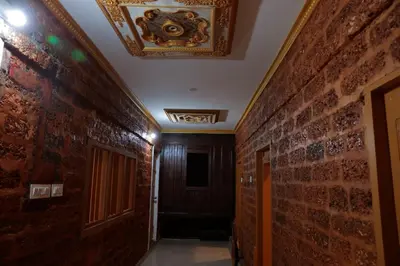 a hallway with a brick wall and a ceiling at Best Heritage Home in Iritti