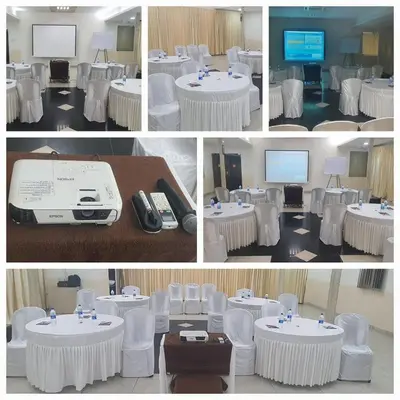 a group of four pictures of a room with white tables and chairs at Hotel Sapthagiri Nest in Coimbatore