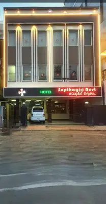 a hotel with a car parked in front of it at Hotel Sapthagiri Nest in Coimbatore