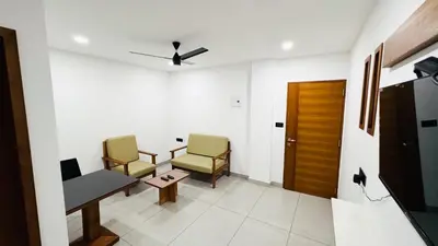 a waiting room with two chairs and a table at Rose Garden at Rajagiri Hospital in Ernakulam