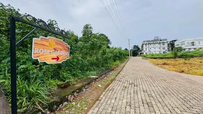 a sign for a roost cluthy on a brick road at Rose Garden at Rajagiri Hospital in Ernakulam