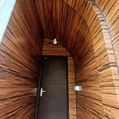 a door in a hallway with a wooden ceiling at Vattavada Jungle Resort in Munnar