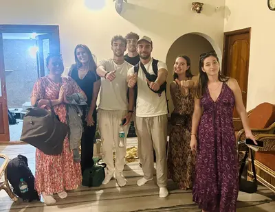 a group of people posing for a picture in a room at Palace Hostel by Borrbo in Mysore