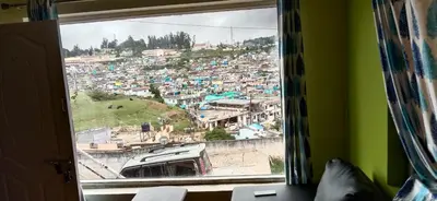 a view of a city from a window at Stay awhile in Ooty