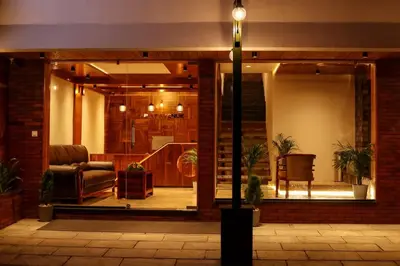 a lobby with a couch and a chair in a building at ARIAT AVENUE in Wayanad