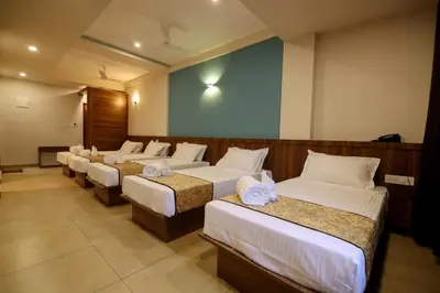 a row of beds in a room at ARIAT AVENUE in Wayanad