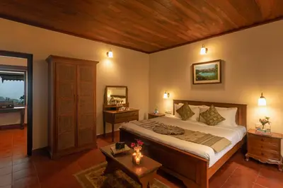 a bedroom with a large bed and a wooden ceiling at Emerald by Nature Resorts and Stays in Ooty