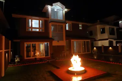 a fire in front of a house at night at HAILSTONE HOME STAY in Ooty